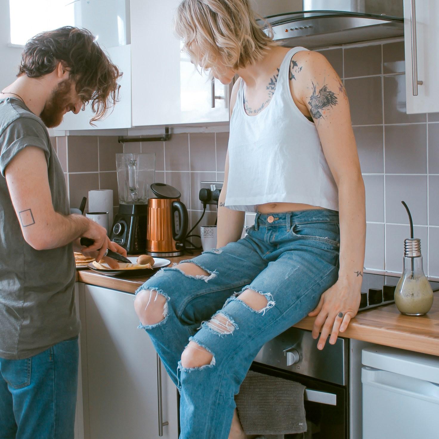 Community members collaborating in a modern kitchen space, sharing recipes and cooking techniques